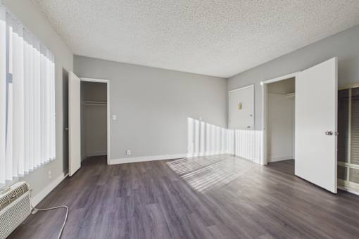A room with wooden floors and white walls.