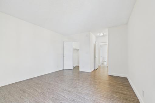 A room with white walls and wooden flooring.