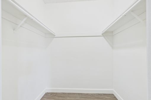A white room with a wooden floor and white walls.