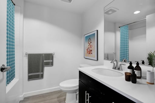 a white bathroom with a sink and a toilet