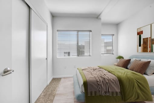 a bedroom with a bed and a window
