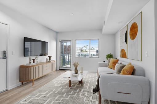 an open living room with a couch and a tv