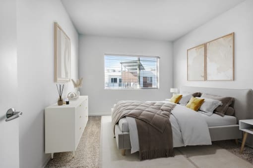 a bedroom with a bed and a large window