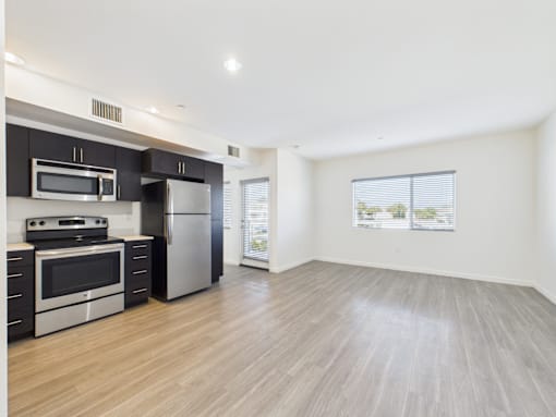 A kitchen with a stainless steel refrigerator and oven.