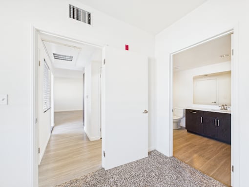 A white door is open to a bathroom.