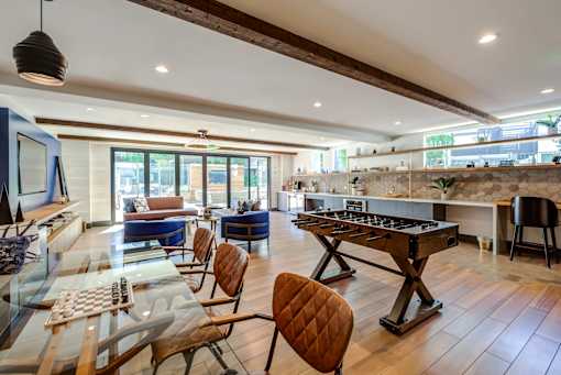 A modern kitchen with a glass table and chairs.