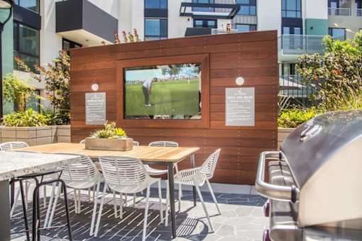 A wooden board with a picture of a person playing tennis is mounted on a wall.