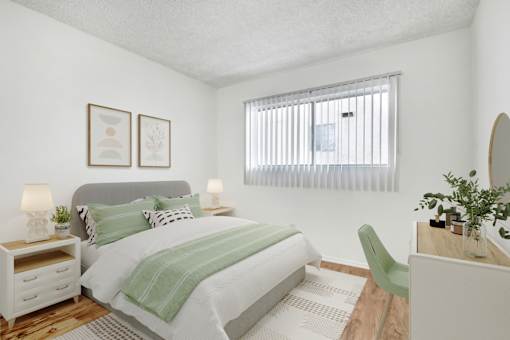 A bedroom with a bed, nightstand, and chair.