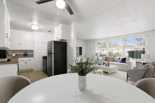 a living room and dining room with a white table