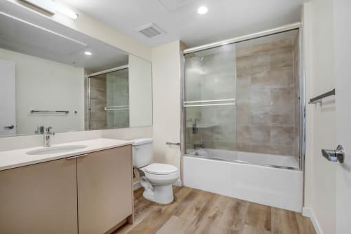 a bathroom with a sink toilet and shower