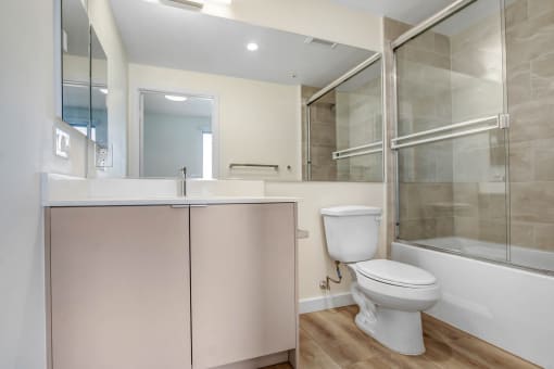 a bathroom with a toilet sink and mirror