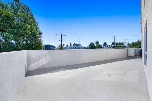 a view from the roof of a building with trees and a blue sky in the background