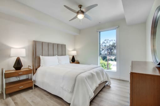 a bedroom with a bed and a ceiling fan