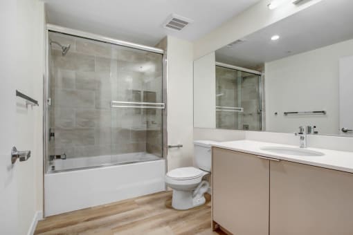 a bathroom with a toilet sink and shower