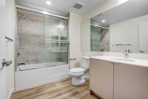 a bathroom with a toilet sink and shower