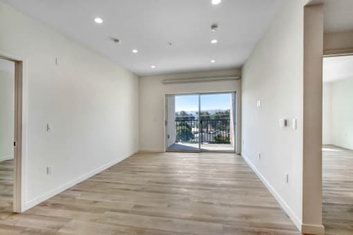 a bedroom with a medium sized bed and a doorway leading to a balcony