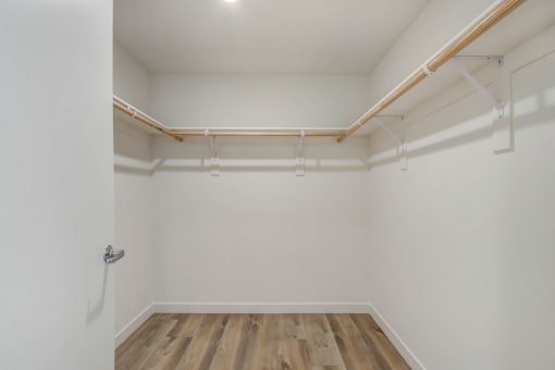 an empty room with white walls and a wooden floor