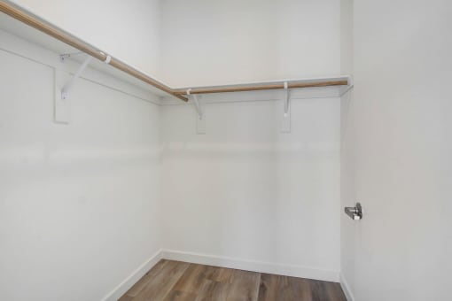 an empty room with white walls and a wooden floor