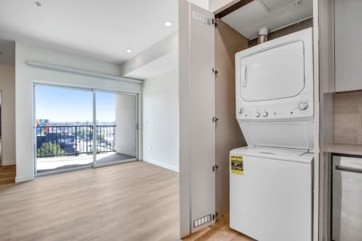 a washer and dryer in a room with a balcony
