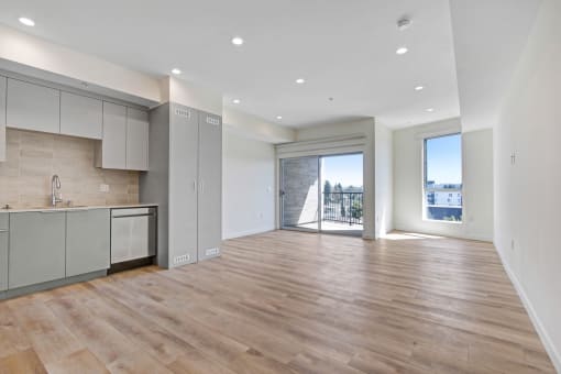 an open living room and kitchen area with a view of a balcony