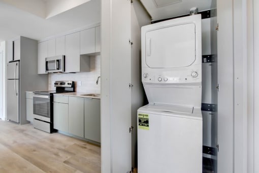 a white washer and dryer in a white kitchen