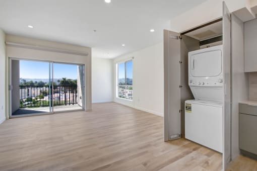 a bedroom apartment in the building with a washer and dryer