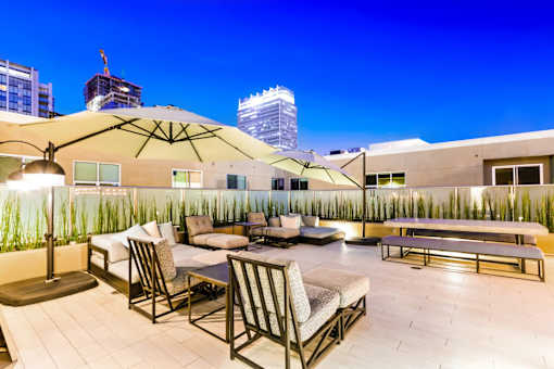 A rooftop patio with a table and chairs.