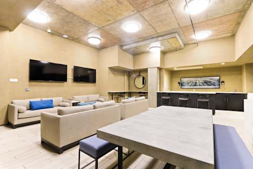 A large room with a long table and two couches.