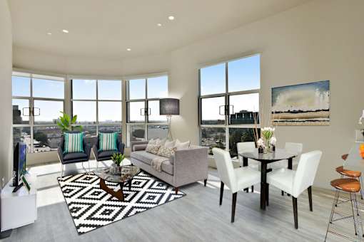 A modern living room with a large window overlooking the city.