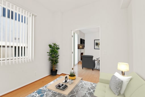 a living room with white walls and hardwood floors