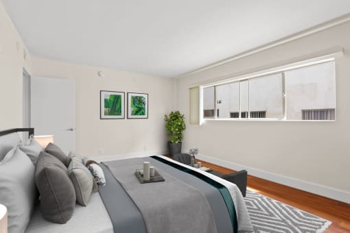 a bedroom with a large bed and a large window