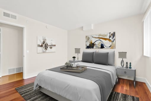 a bedroom with a medium sized bed and a door that leads to a bathroom