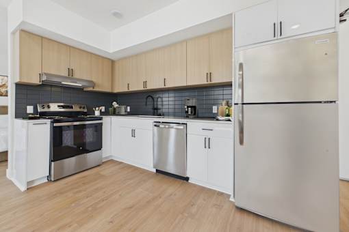 A modern kitchen with wooden cabinets and stainless steel appliances.
