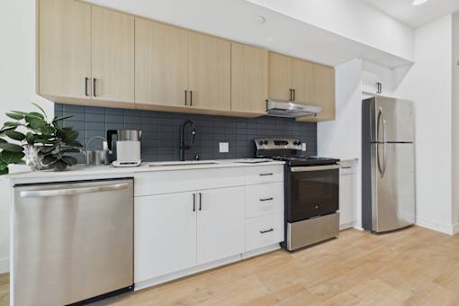 A modern kitchen with wooden cabinets and stainless steel appliances.