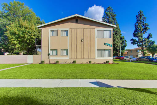12082 Cole side view building, lush landscaping, street parking on the left side