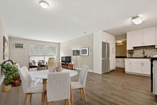 Dining Area With wood-style floors throughout and a kitchen to the right