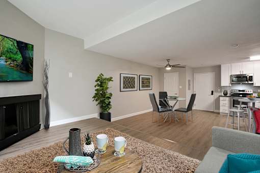Den with cozy fireplace, wood inspired floors