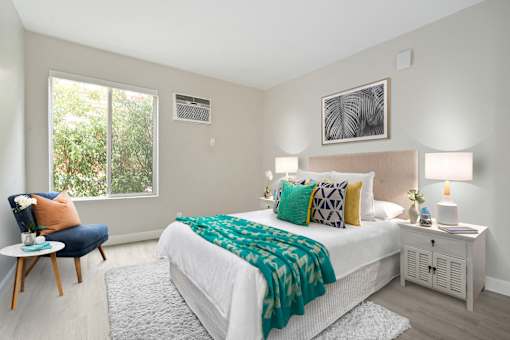 Bedroom with air conditioning, wood-inspired floors, sliding window