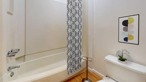 a bathroom with a shower and a sink and a toilet
