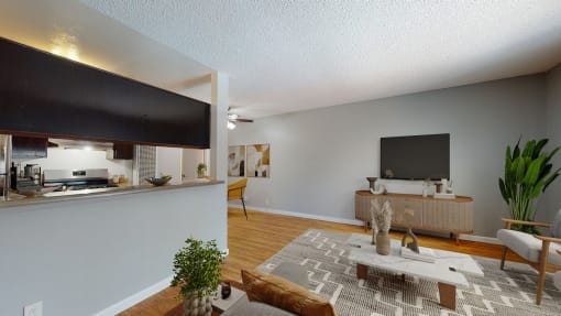 an open living room and kitchen with a large television