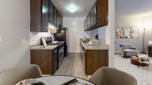 a kitchen and living room with a table and chairs in a home