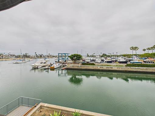 A marina with boats docked and a cloudy sky.