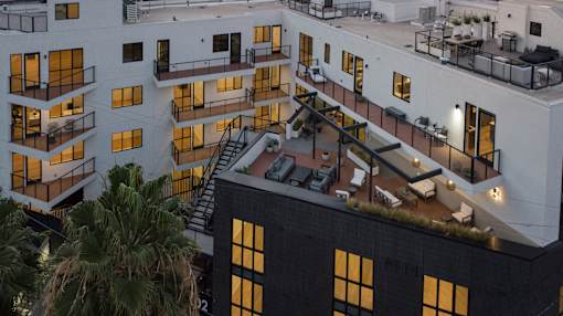 A modern building with balconies and a staircase.