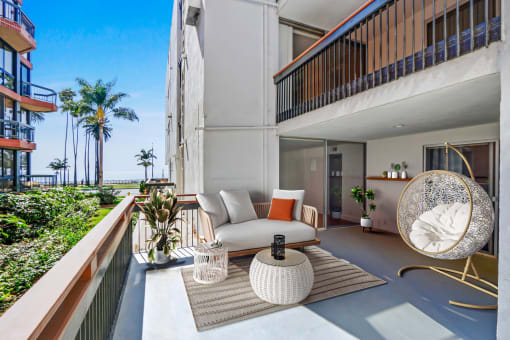 a living room with a couch and a table on a balcony