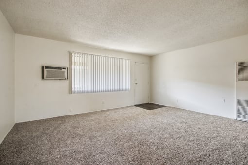 Living room with carpeted floors, air conditioning