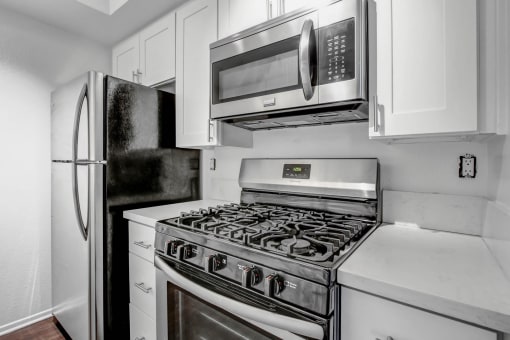 a kitchen with a stove top oven next to a refrigerator
