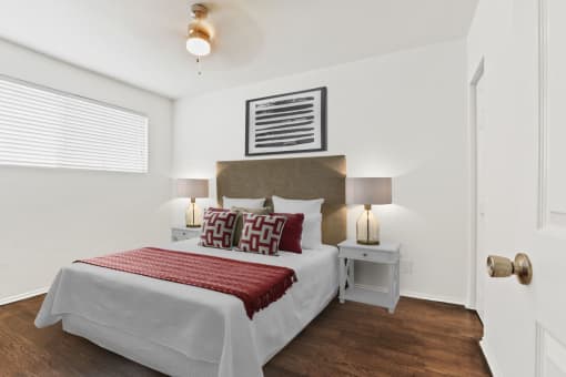 a bedroom with a bed and two nightstands
