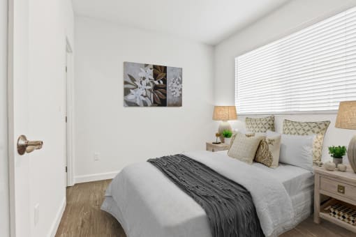 a bedroom with a bed and two night stands with lamps