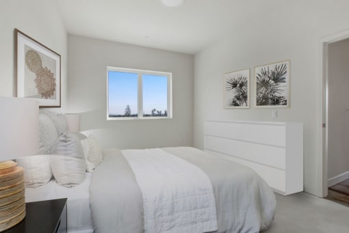 a bedroom with a bed and two windows