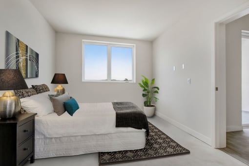 a bedroom with a bed and a window
